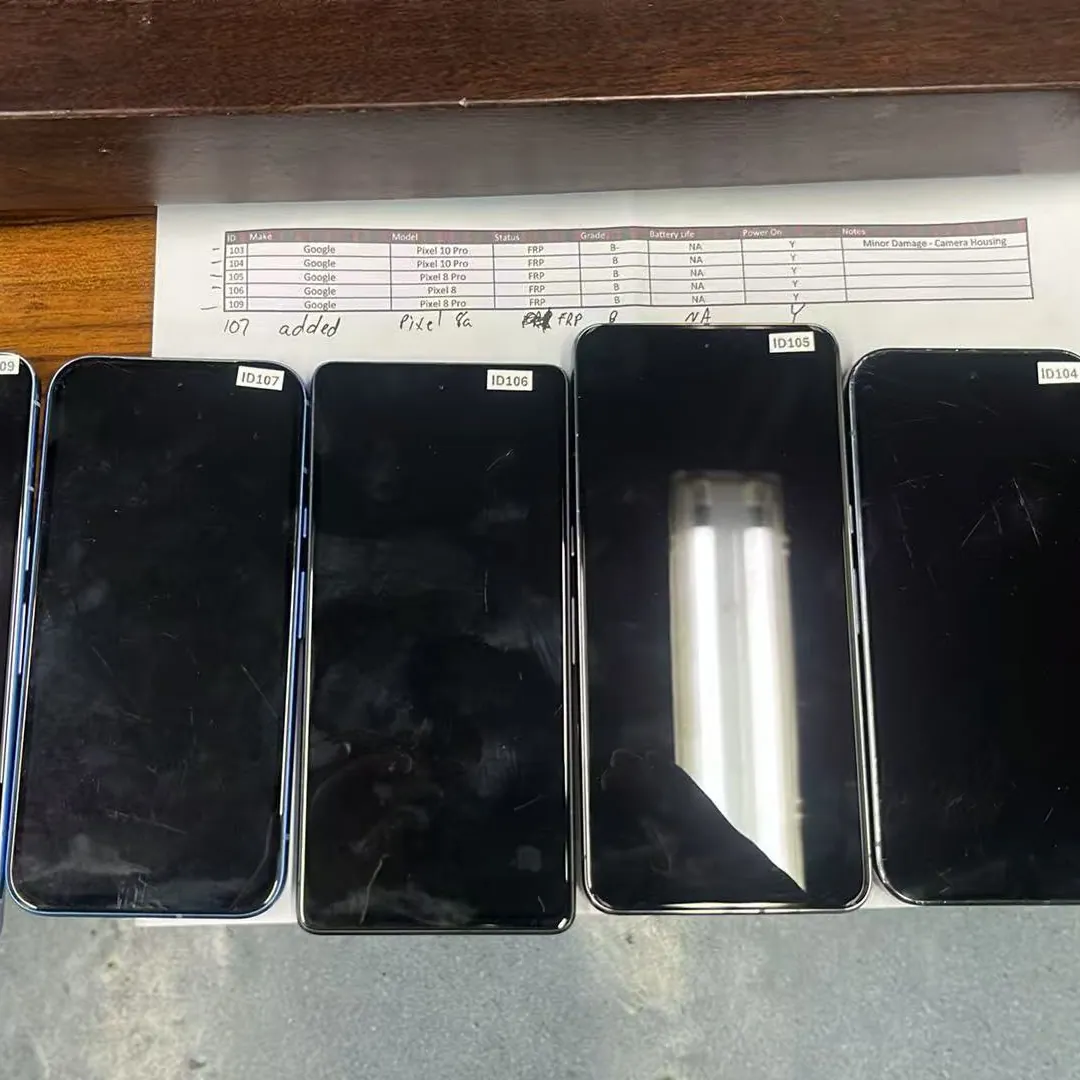 Graded used smartphones laid out in a grid, each with a paper grade tag